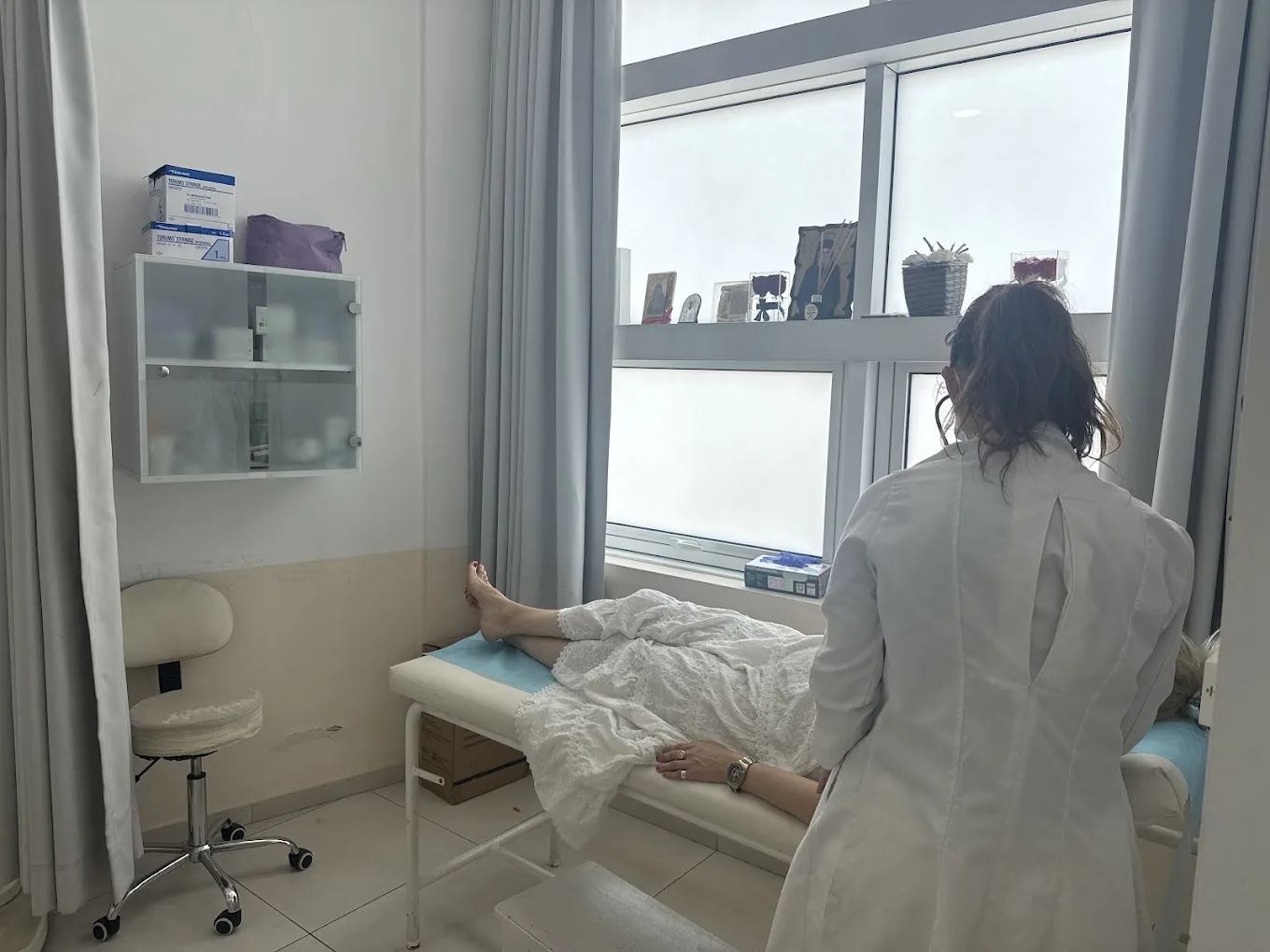 The doctor caring for a patient in the examination room